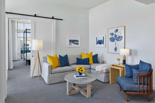 a living room with a couch and a table at The Seabird Ocean Resort & Spa, Part of Destination Hotel by Hyatt in Oceanside