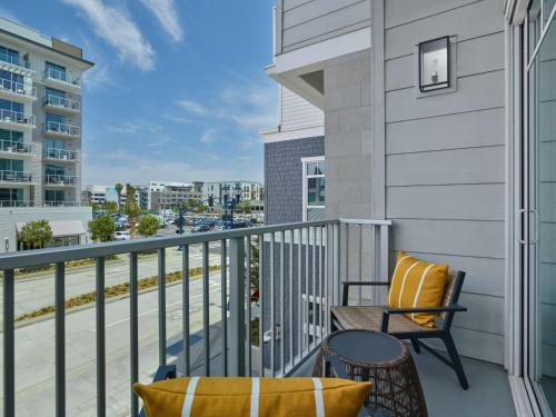 a balcony with a table and chairs and a view of a street at The Seabird Ocean Resort & Spa, Part of Destination Hotel by Hyatt in Oceanside