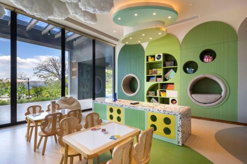 a dining room with green walls and tables and chairs at Waldorf Astoria Costa Rica Punta Cacique in Playa Hermosa
