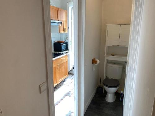 Il comprend une petite salle de bains pourvue de toilettes et une cuisine. dans l'établissement Charmant appartement parisien !, à Paris
