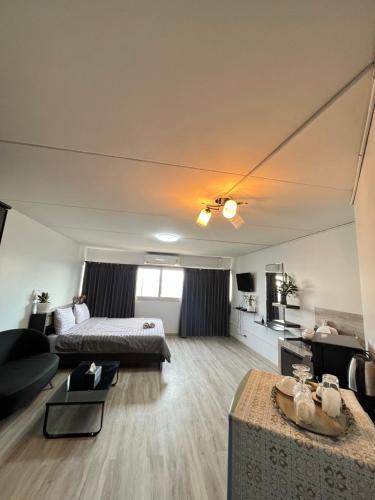 a large living room with a bed and a couch at T12 Popular Condo By : hunnity in Ban Bang Phang