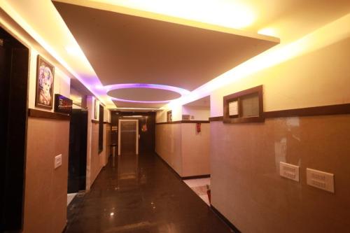 a hallway with a purple light in a building at Shanti Sewa Dham in Chhatikara