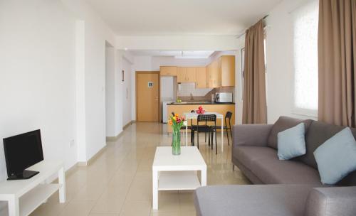 a living room with a couch and a table at Valentinos Apartments in Paphos City