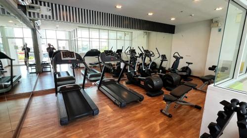 a gym with several treadmills and elliptical machines at The Coast in Bangkok