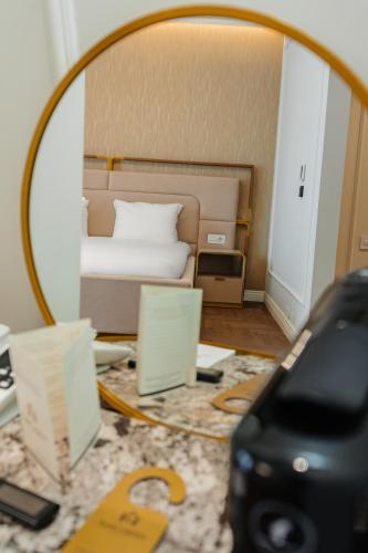 a hotel room with a bed and a mirror at SunGarden Golf & Spa Resort in Cluj-Napoca