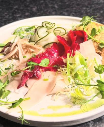 a plate of food with vegetables on a table at White Hart Hotel in Dorchester on Thames