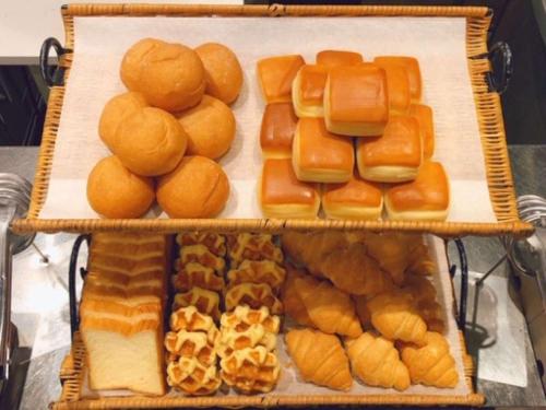a tray filled with lots of different types of pastries at Dormy Inn Premium Namba Natural Hot Spring in Osaka