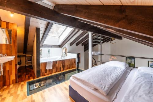 an attic bedroom with a bed and a sink at alt Hischi Villa Emanuel old Zermatt in Zermatt