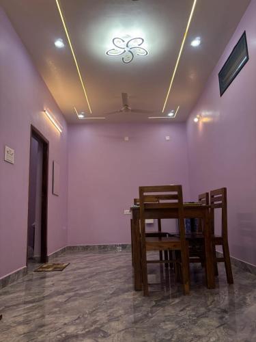 a dining room with a table and two chairs at Delight villa in Kottakupam