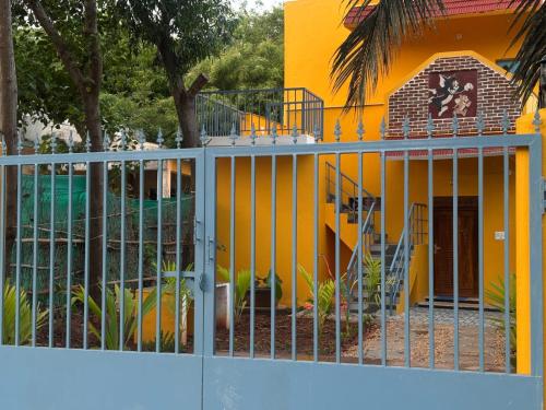 a fence in front of a house with a playground at Delight villa in Kottakupam
