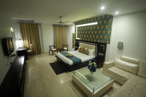 a living room with a bed and a couch at Shanti Sewa Dham in Chhatikara