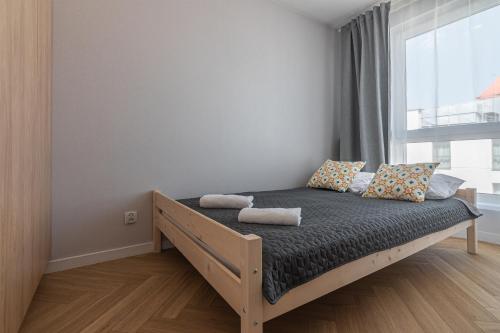 a bed in a room with a window at Apartament Bulwary 36 in Oświęcim