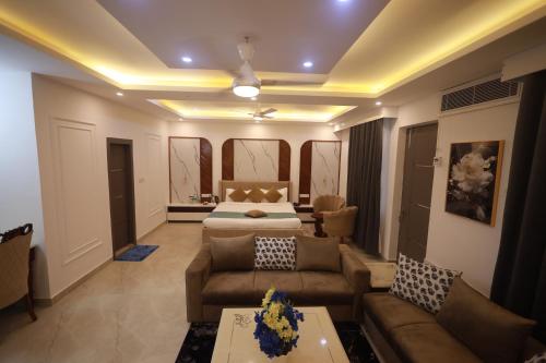 a living room with a bed and a couch at Shanti Sewa Dham in Chhatikara