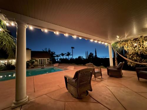 a patio with lights and a swimming pool at night at Riverside Views & Pool Retreat in Riverside