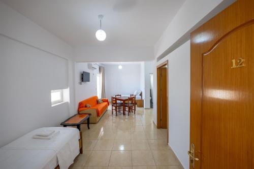 a room with a bed and a couch and a table at Aleksander ApartHotel in Ksamil