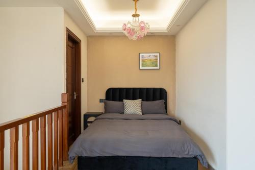 a bedroom with a bed and a chandelier at 重庆乐隐江景民宿 in Chongqing