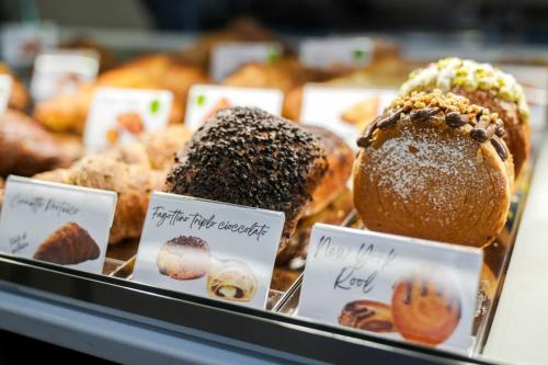 a bunch of pastries in a display case in a bakery at Edward Rooms & Wellness B&B in Trani