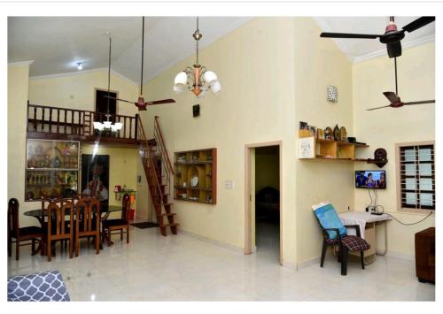 a living room and dining room with a table and chairs at Sagar Krupa Homestay, Udipi Staycation in Udupi
