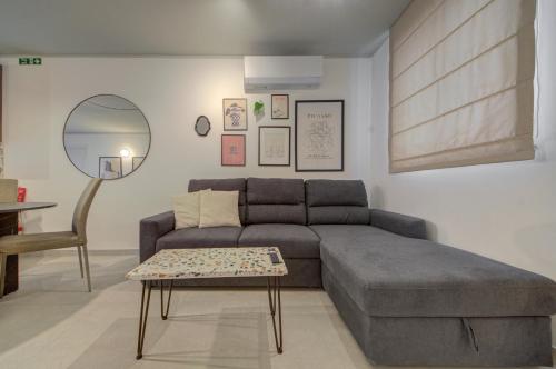 a living room with a couch and a table at Juliet Residence, Apt 4 , Your Home Away from Home in Gzira by SF HOMES in Il-Gżira