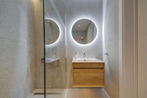 a bathroom with a sink and a glass shower at Juliet Residence, Apt 4 , Your Home Away from Home in Gzira by SF HOMES in Il-Gżira