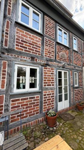 a brick house with two windows and a porch at Ferienhaus St. Johannis in Werben
