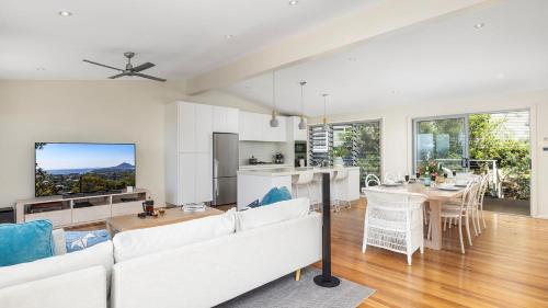 a living room with a white couch and a table at Hamptons By The Bay in Nelson Bay