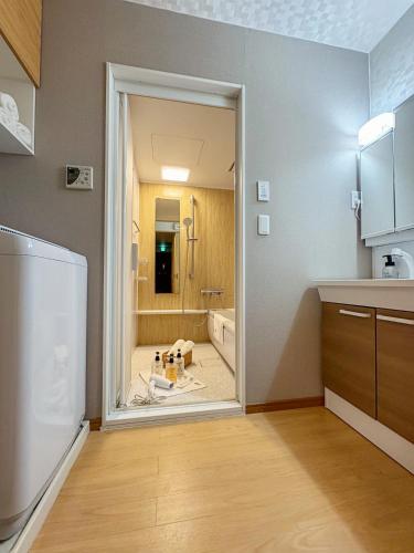 a kitchen with a door open to a bathroom at 桜の川17 JR上野駅3分钟 11人房 4LDK 110平别墅丨Ueno Villa 3 minutes from Ueno Station 11 people in Tokyo