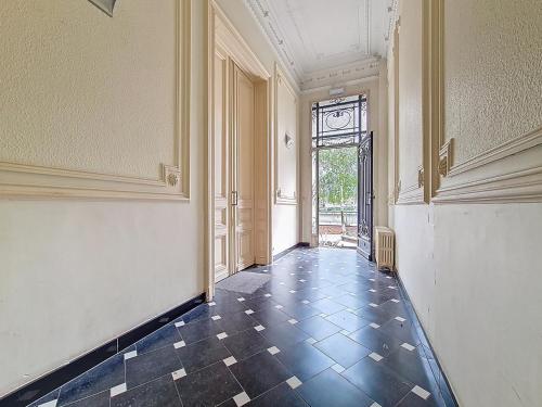 an empty hallway with a tile floor and a window at Amazing Studio Charleroi Central Station in Charleroi