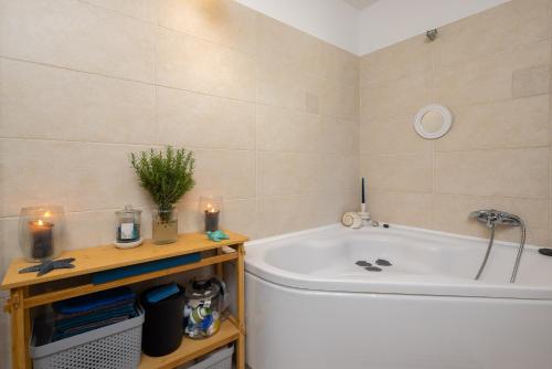 a bathroom with a tub and a sink at Apartment GL in Stanići