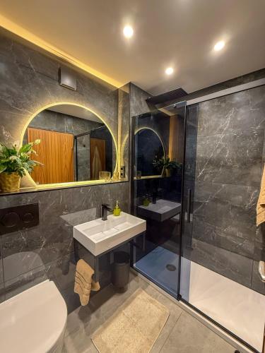 a bathroom with a toilet and a sink and a shower at Watzmann Juwel in Berchtesgaden