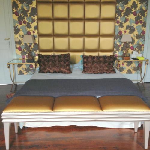 a large bed in a room with at La Rebière d'Or, B&B et Gîte in Mouleydier