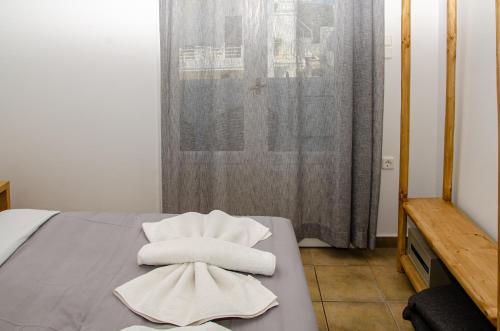 a room with a bed with towels on it at Hotel Livadia in Parikia
