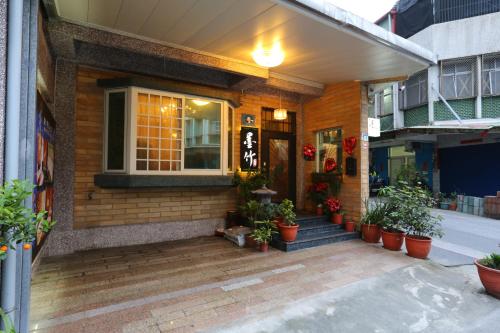 a house with potted plants in front of it at Mozhu B&B in Hualien City