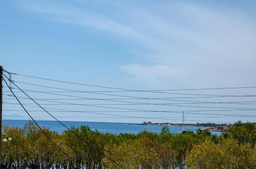 a view of a body of water with power lines at Hotel Livadia in Parikia