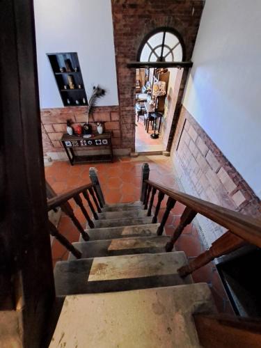 a staircase leading to a room with a brick wall at 八八金歐王金城洋樓古厝民宿 in Jinsha