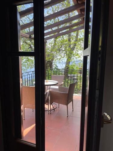 a view from the door of a patio with a table and chairs at Hotel Maistra in Tsagarada