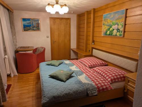 a bedroom with a bed and a desk and a chair at Montahaus Retro Apartments in Vandans