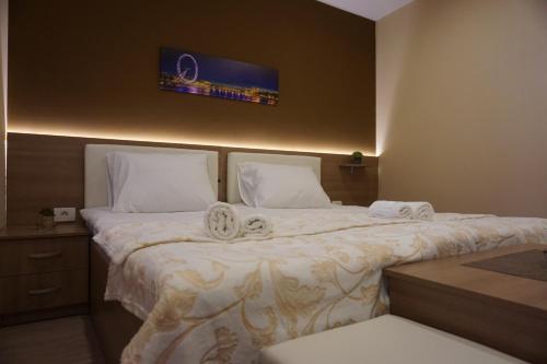 a bedroom with two beds with towels on them at Rooms and Apartment Soča Kobarid in Kobarid