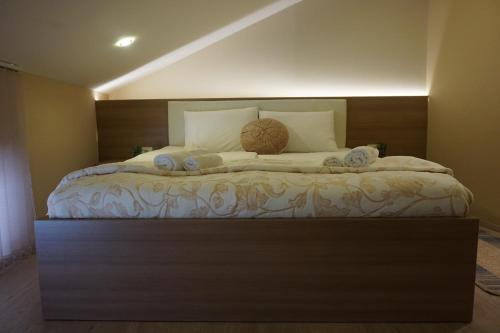 a bedroom with a large bed with towels on it at Rooms and Apartment Soča Kobarid in Kobarid