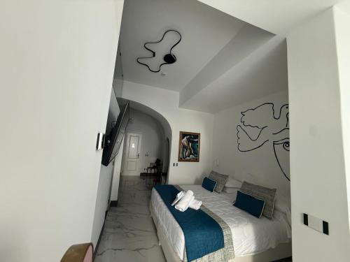 a bedroom with a bed in a white room at Positano Art Hotel Pasitea in Positano