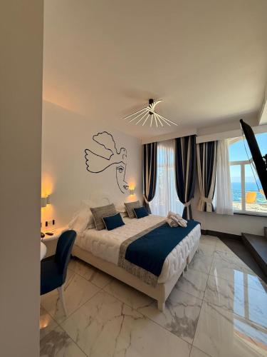 a bedroom with a bed and a desk and a window at Positano Art Hotel Pasitea in Positano
