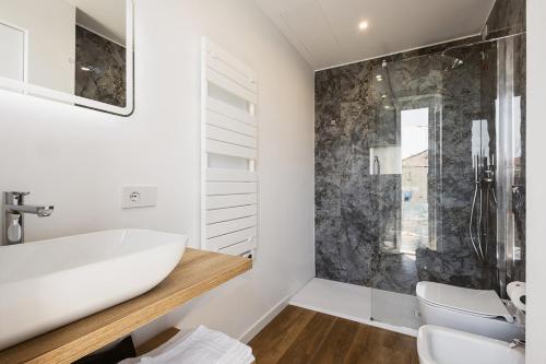 a bathroom with a white sink and a shower at Sanremissimo Rooms & Apartment in Sanremo