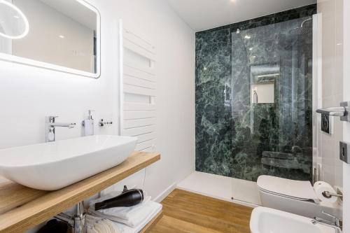a bathroom with a white sink and a mirror at Sanremissimo Rooms & Apartment in Sanremo