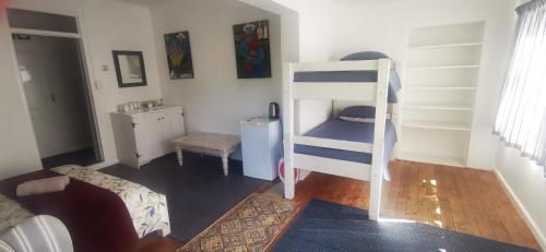 a small room with a bunk bed in a room at Hermanus Backpackers & Budget Accommodation in Hermanus