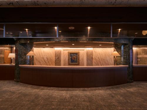 a lobby with a long counter in a building at Mission Hills Hotel in Minano