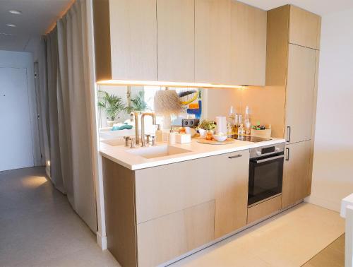 une cuisine avec des armoires blanches et un évier dans l'établissement Beautiful apartment with panoramic sea view, à Antibes