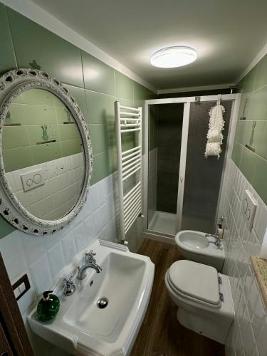 a bathroom with a sink and a toilet and a mirror at Numero 33 in Cori