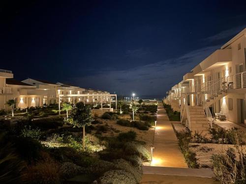 a row of white apartment buildings at night at Lady Marzamemi in Marzamemi