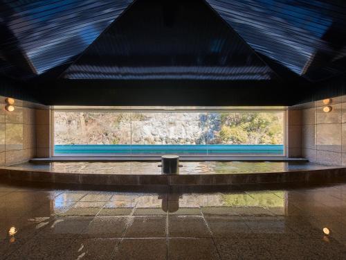 a room with a large window in a building at Mission Hills Hotel in Minano