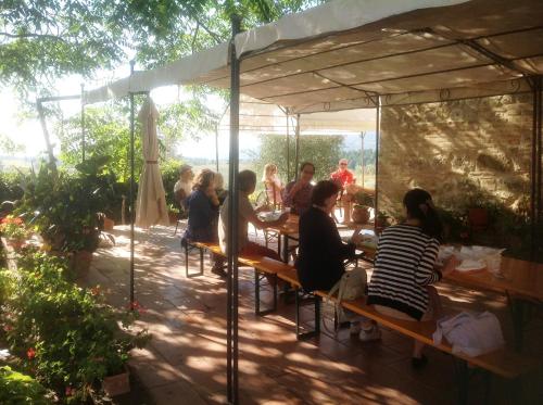a group of people sitting at a table under a tent at Marco & Andrea Agriturismo Collepina in Amelia